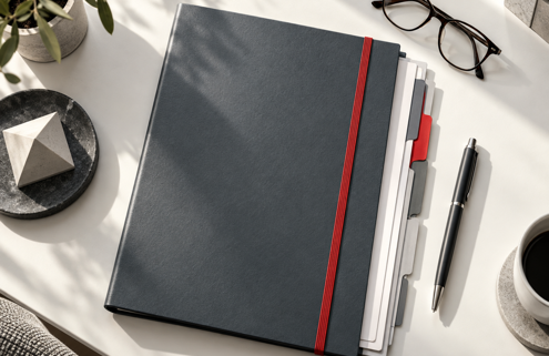 Slate pension review folder with organised dividers on a modern desk